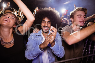 Portrait of man amidst crowd at nightclub