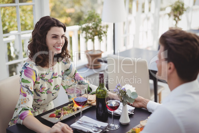 Romantic couple interacting while having meal