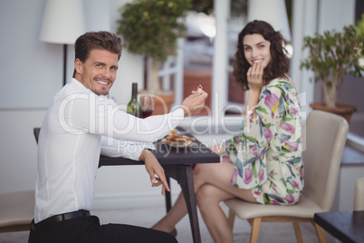 Portrait of man offering engagement ring to woman