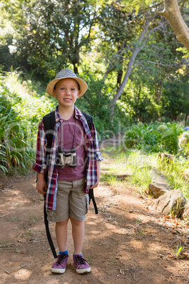 Smiling boy standing in the forest