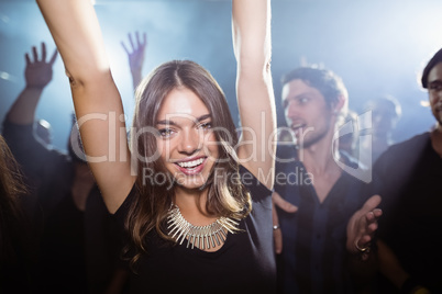 Portrait of happy woman dancing at nightclub