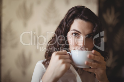 Thoughtful woman having coffee