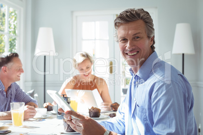 Smiling executive using digital tablet