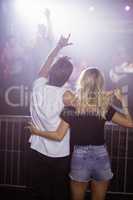 Rear view of couple enjoying at nightclub