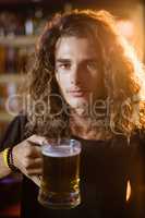 Portrait of young man holding drink