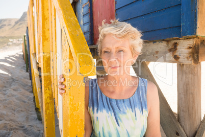 Close up senior woman looking away while sitting by hut