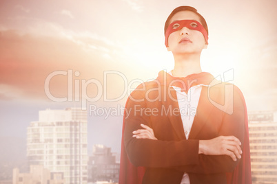 Composite image of confident woman pretending to be super hero