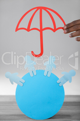 Composite image of hand holding a red umbrella