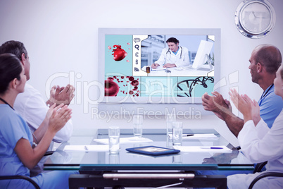 Composite image of team of doctor applauding during meeting