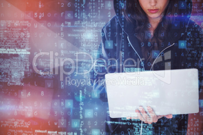 Composite image of focused female hacker in black hoodie using laptop