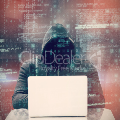 Composite image of focused male hacker using laptop