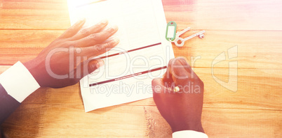 Hands of a man signing insurance document