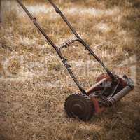 Man with lawnmower on grass