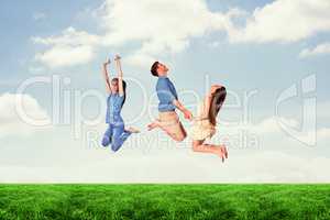 Composite image of happy friends jumping