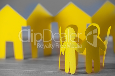 Paper figures and houses on table