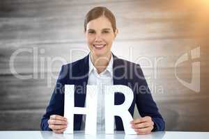 Composite image of business woman smiling and holding letters h and r