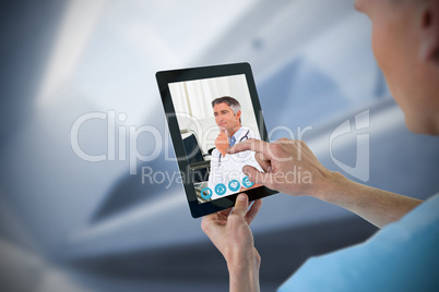 Composite image of male nurse using digital tablet
