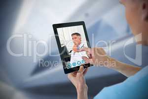 Composite image of male nurse using digital tablet