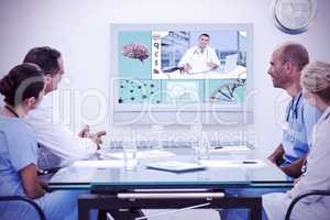 Composite image of team of doctors having a meeting