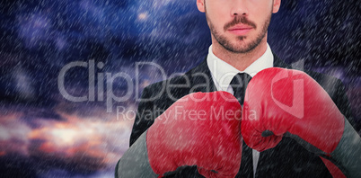 Composite image of businessman with boxing gloves