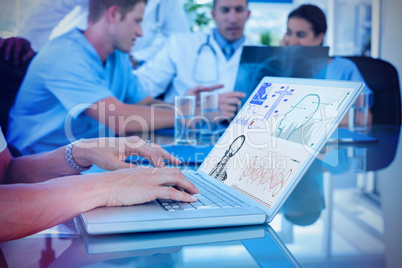 Composite image of doctor typing on keyboard with her team behind