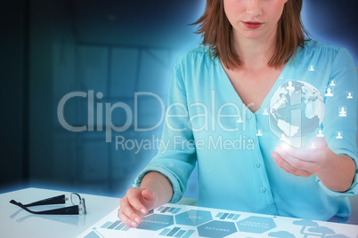 Composite image of businesswoman sitting at desk and using digital screen