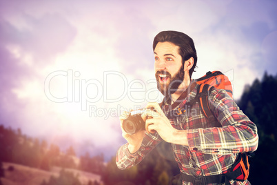 Composite image of happy hiker taking picture through camera