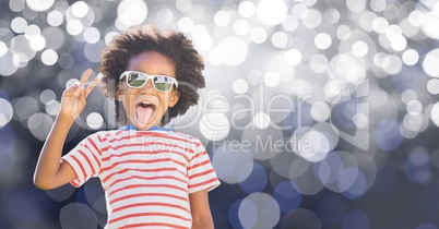 Young boy sticking out tongue while gesturing victory sign