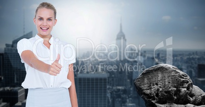 Businesswoman showing thumbs up against city