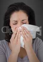 Woman crying into tissue against grey wall