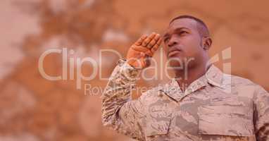 Soldier saluting against blurry brown map with red overlay