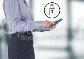 Business woman with tablet and white lock graphic against blurry office