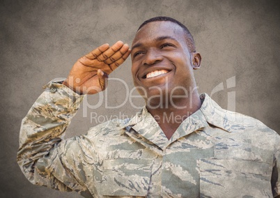 Soldier smiling and saluting against brown background with grunge overlay