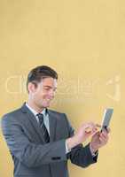 Smiling businessman using smart phone over yellow background
