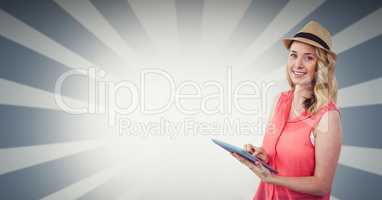 Female hipster holding tablet PC against bright background