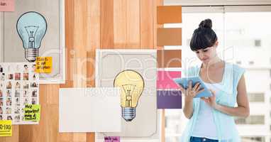 Businesswoman using tablet PC by graphics in office
