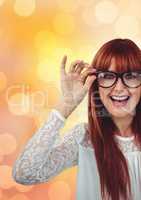 Cheerful female hipster wearing eyeglasses over bokeh