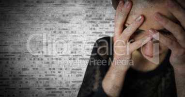 Woman hands over face against white brick wall with grunge overlay