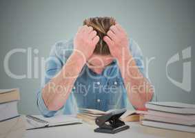Stressed man at desk against light blue background
