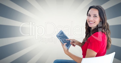 Smiling woman using tablet PC against bright background