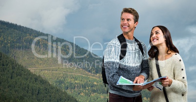 Thoughtful hiking couple holding map on mountain