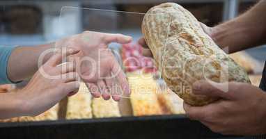 Hands photographing bread on transparent device