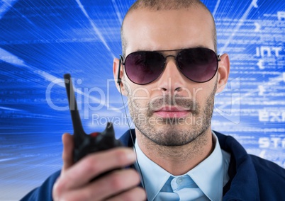 Security guard wearing sunglasses while holding radio