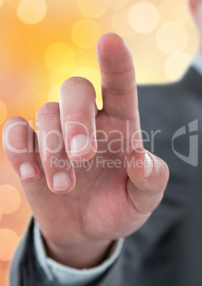 Business person touching imaginary screen over bokeh