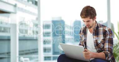 Hipster using laptop in office