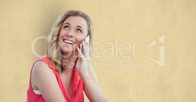Smiling woman using smart phone over beige background