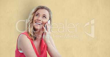 Smiling woman using smart phone over beige background