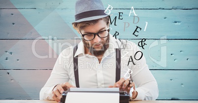 Hipster using typewriter while letters flying against wall