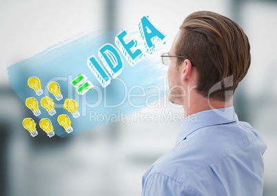 Business man looking at lightbulb doodle against blurry grey office