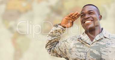 Soldier smiling and saluting against blurry yellowish map